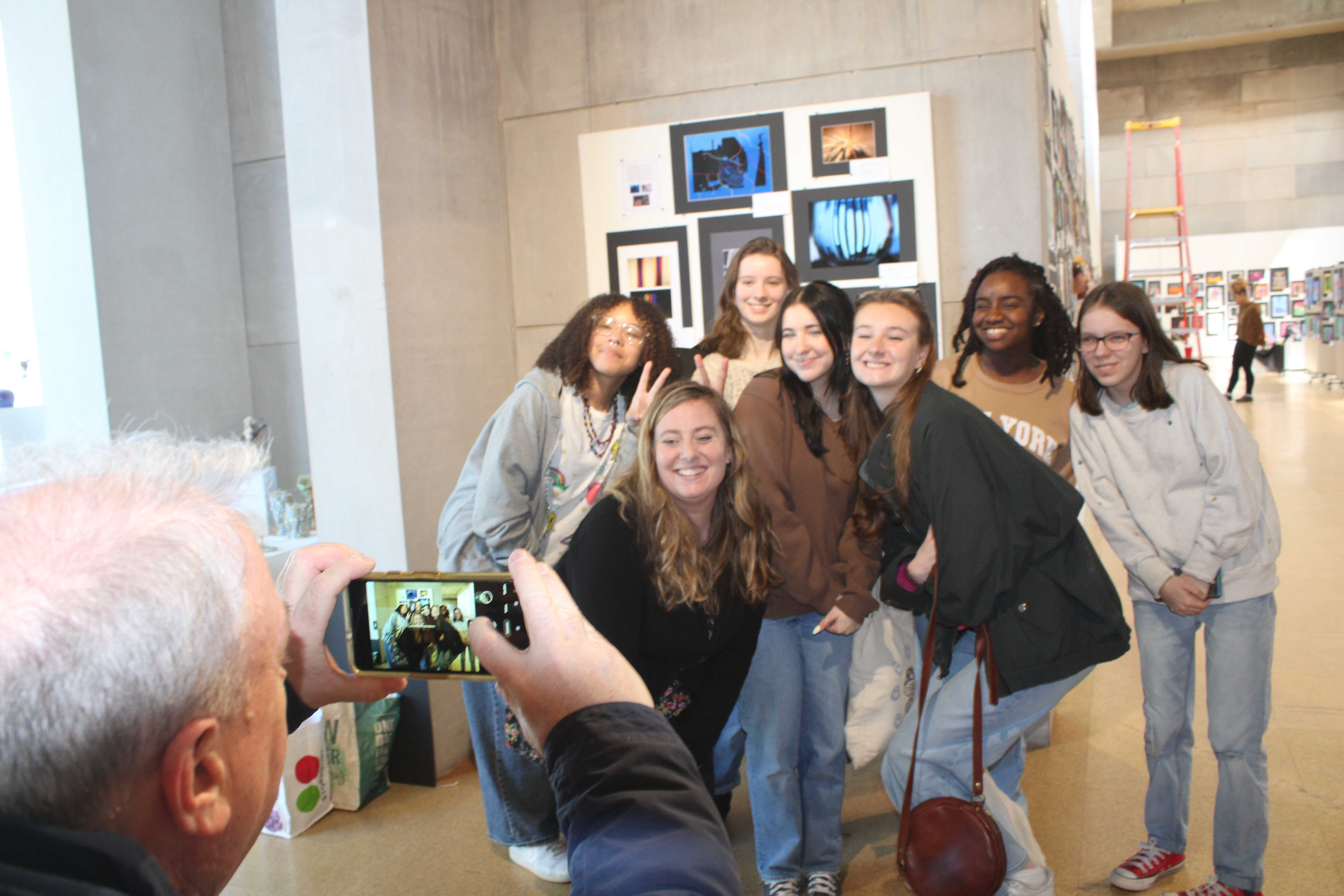 Students pose for a photo as they prepare for the art show